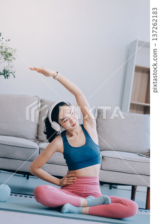 Young Asian sporty attractive people practicing yoga lesson with instructor. Asia group of women exercising healthy lifestyle in fitness studio. Sport activity, gymnastics or ballet dancing class. 137262183