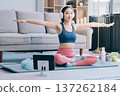 Young Asian sporty attractive people practicing yoga lesson with instructor. Asia group of women exercising healthy lifestyle in fitness studio. Sport activity, gymnastics or ballet dancing class. 137262184