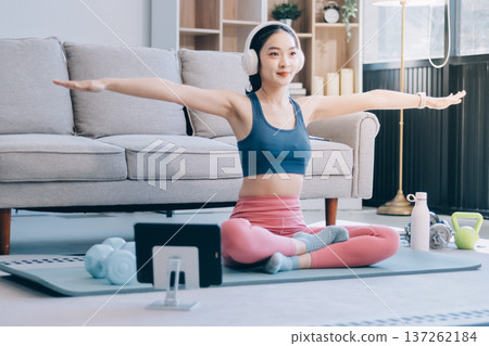 Young Asian sporty attractive people practicing yoga lesson with instructor. Asia group of women exercising healthy lifestyle in fitness studio. Sport activity, gymnastics or ballet dancing class. 137262184