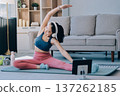 Young Asian sporty attractive people practicing yoga lesson with instructor. Asia group of women exercising healthy lifestyle in fitness studio. Sport activity, gymnastics or ballet dancing class. 137262185