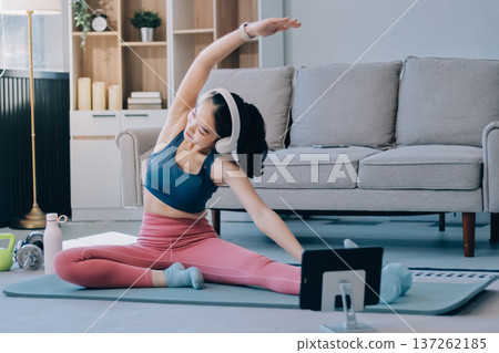 Young Asian sporty attractive people practicing yoga lesson with instructor. Asia group of women exercising healthy lifestyle in fitness studio. Sport activity, gymnastics or ballet dancing class. Young Asian sporty attractive people practicing yoga lesson with instructor. Asia group of women exercising healthy lifestyle in fitness studio. Sport activity, gymnastics or ballet dancing class. 137262185