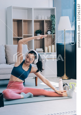 Young Asian sporty attractive people practicing yoga lesson with instructor. Asia group of women exercising healthy lifestyle in fitness studio. Sport activity, gymnastics or ballet dancing class. 137262187