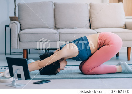 Young Asian sporty attractive people practicing yoga lesson with instructor. Asia group of women exercising healthy lifestyle in fitness studio. Sport activity, gymnastics or ballet dancing class. 137262188