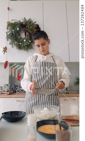 Home cook enjoying festive moments while mixing ingredients cheerfully Home cook enjoying festive moments while mixing ingredients cheerfully 137262484