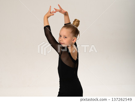 Young dancer with cochlear implant performing expressive sport dance movement. Hearing loss rehabilitation, auditory therapy, assistive technology, physical coordination, and confidence growth 137262549
