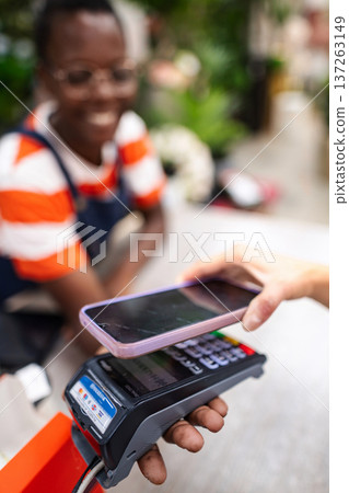 Customer paying with smartphone at a flower shop 137263149