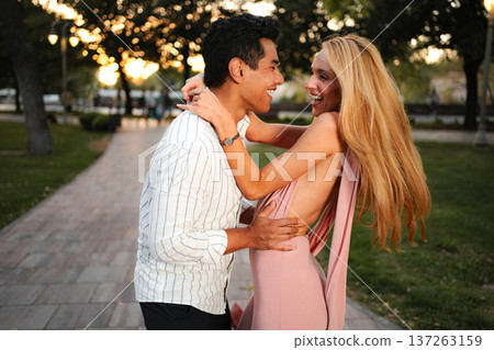 Joyful couple embracing during sunset in beautiful park setting 137263159