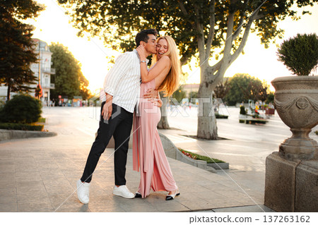 Couple shares a romantic moment in the golden light of dusk 137263162