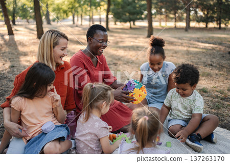 Children and teachers enjoying playtime together outdoors Children and teachers enjoying playtime together outdoors 137263170