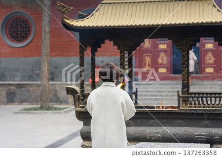 People burning Incense at the White Horse Temple, old Buddhist temple in Luoyang in Henan province in China People burning Incense at the White Horse Temple, old Buddhist temple in Luoyang in Henan province in China 137263358
