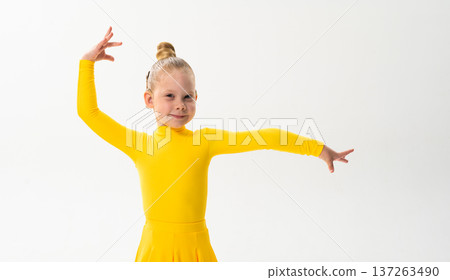 Young dancer with cochlear implant performing dance pose. Strength, adaptability, and inclusion merge in a story of overcoming hearing barriers through art, discipline, and body control. 137263490
