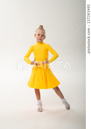 Child with cochlear implant performing expressive sport dance movement in studio. Hearing loss rehabilitation, auditory therapy, assistive technology, physical recovery, and inclusive development 137263495