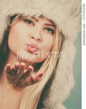 Blonde woman in winter furry hat 137263584