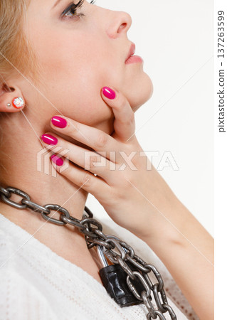 Woman having metal chain around neck 137263599