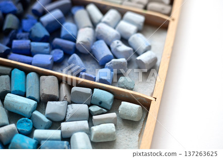 Pieces of soft pastel chalks in a wooden art supply storage box. Art supplies in a storage case Pieces of soft pastel chalks in a wooden art supply storage box. Art supplies in a storage case 137263625