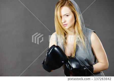 Boxer girl exercise with boxing gloves. 137263642