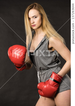 Beautiful woman with red boxing gloves Beautiful woman with red boxing gloves 137263644