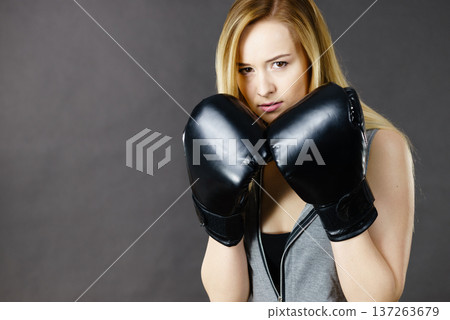 Boxer girl exercise with boxing gloves. Boxer girl exercise with boxing gloves. 137263679