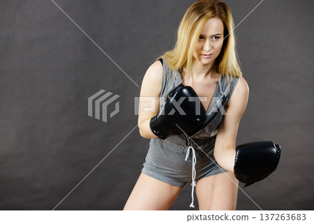 Boxer girl exercise with boxing gloves. Boxer girl exercise with boxing gloves. 137263683