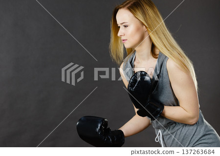 Boxer girl exercise with boxing gloves. 137263684