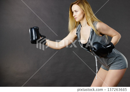 Boxer girl exercise with boxing gloves. Boxer girl exercise with boxing gloves. 137263685