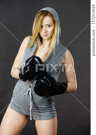 Boxer girl exercise with boxing gloves. 137263688
