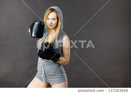 Boxer girl exercise with boxing gloves. Boxer girl exercise with boxing gloves. 137263689