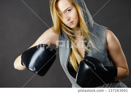 Boxer girl exercise with boxing gloves. Boxer girl exercise with boxing gloves. 137263691