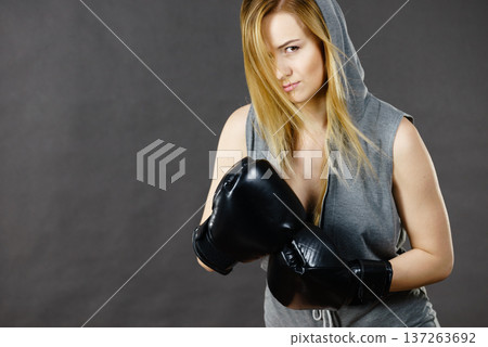 Boxer girl exercise with boxing gloves. Boxer girl exercise with boxing gloves. 137263692