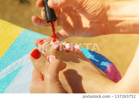 Woman pedicure with red nail polish Woman pedicure with red nail polish 137263752