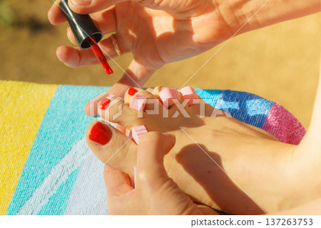 Woman pedicure with red nail polish Woman pedicure with red nail polish 137263753