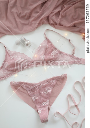 Woman's lingerie on the bed sheets. Lace sexy female underwear. Beauty, fashion blogger concept. Female bra, panties, erotic clothes. Lingerie advertising Woman's lingerie on the bed sheets. Lace sexy female underwear. Beauty, fashion blogger concept. Female bra, panties, erotic clothes. Lingerie advertising 137263769