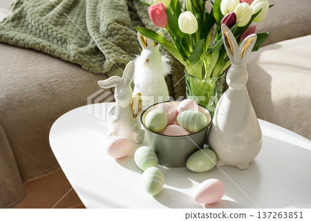Living Room Decorated Easter Eggs with Bunny Figurines and Tulips. Cozy Spring Holiday Arrangement Living Room Decorated Easter Eggs with Bunny Figurines and Tulips. Cozy Spring Holiday Arrangement 137263851