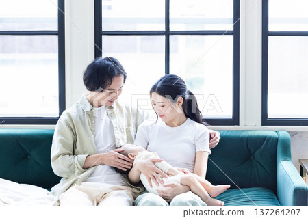 A couple holding a baby A couple holding a baby 137264207