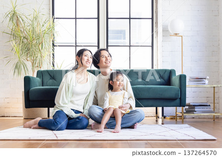 A family relaxing in the living room A family relaxing in the living room 137264570