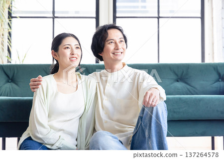 A young couple relaxing in the living room A young couple relaxing in the living room 137264578