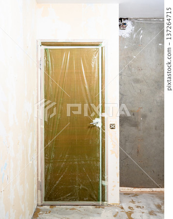 door covered with protective film in room 137264715