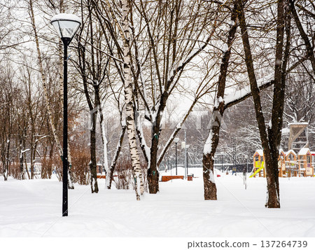 snow-covered city garden with playground in winter snow-covered city garden with playground in winter 137264739