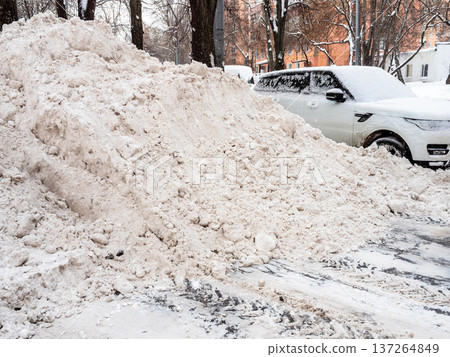 pile of snow cleared from street on road in city 137264849