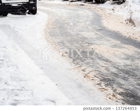 cleared frozen and snow-covered surface of road 137264853