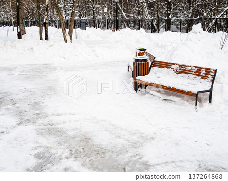 wooden bench in city garden cleared after snowfall wooden bench in city garden cleared after snowfall 137264868