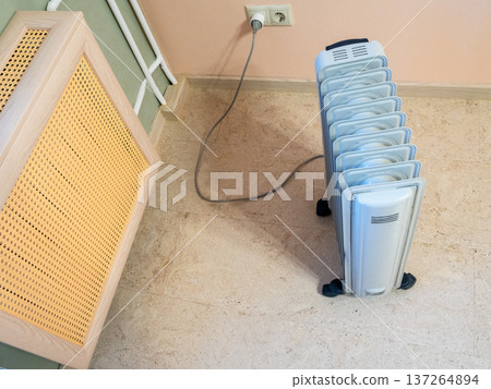 above view of oil heater and heating radiator above view of oil heater and heating radiator 137264894