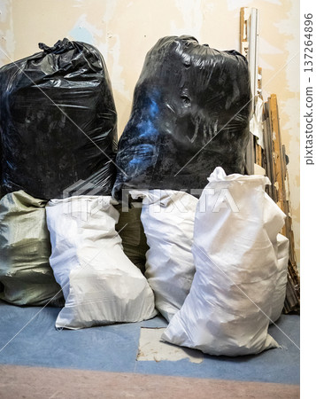 construction waste in bags against wall of room construction waste in bags against wall of room 137264896