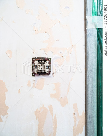 switch on wall of room stripped of wallpaper 137264901