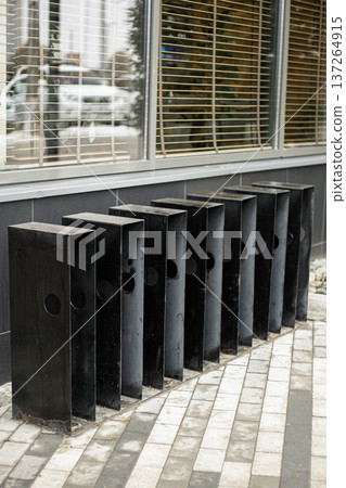 Installed metal bicycle racks in urban area, public parking solution for cyclists Installed metal bicycle racks in urban area, public parking solution for cyclists 137264915