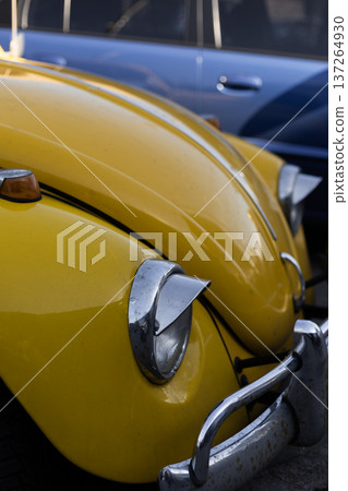 Close up of vintage yellow car headlight and front bodywork. Close up of vintage yellow car headlight and front bodywork. 137264930