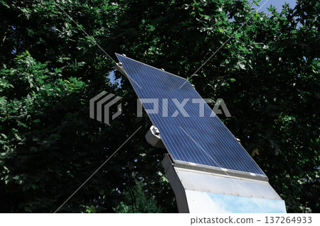 Solar panel for charging gadgets in a park Solar panel for charging gadgets in a park 137264933
