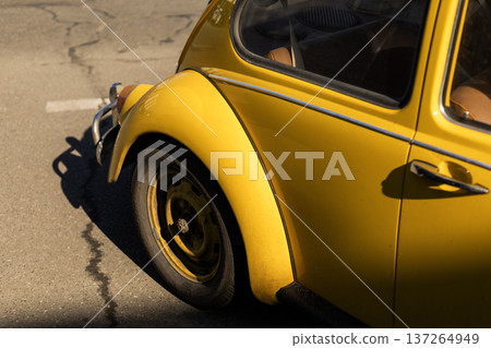 Detail of vintage yellow car back wheel and fender design. Detail of vintage yellow car back wheel and fender design. 137264949