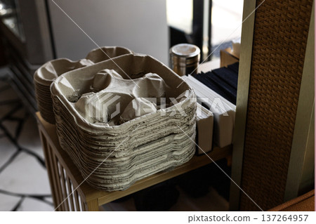 Self service coffee station with cup holders, napkins, sugar and straws in cafe interior. 137264957