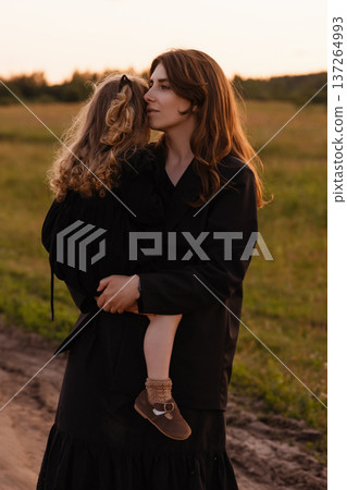 Rural Dusk Mother. Quiet Evening Moment Of Mother And Child Along Peaceful Country Dirt Path Rural Dusk Mother. Quiet Evening Moment Of Mother And Child Along Peaceful Country Dirt Path 137264993